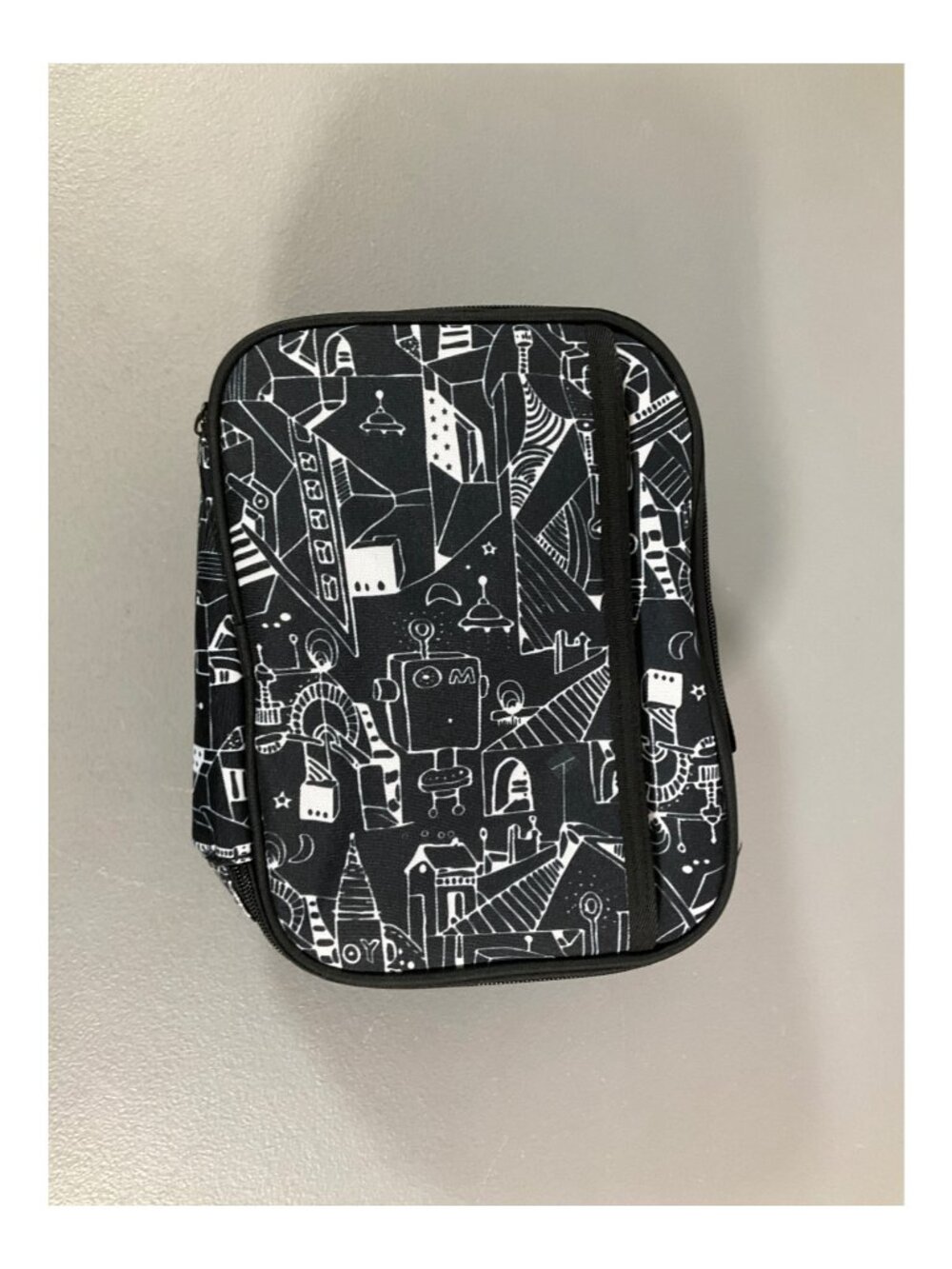 Black Insulated Lunch Bag with Robot-Inspired Abstract Design and Zipper Closure